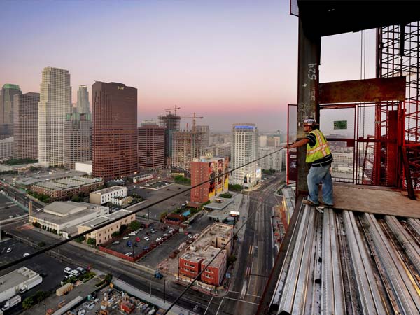 High-rise construction project with cranes and workers at an active urban job site